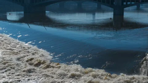 Water flowing under a bridge Stock Footage 310933148