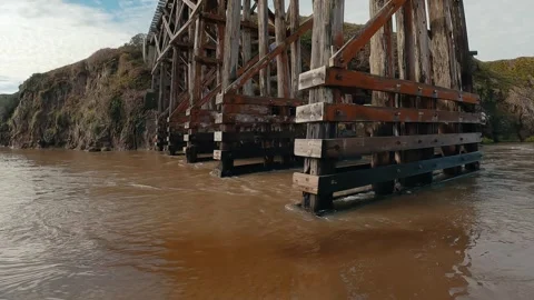 Water flowing under pudding train bridge Stock Footage 265133267