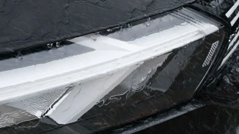 Water flows across a black car surface during washing Stock Footage 340629913