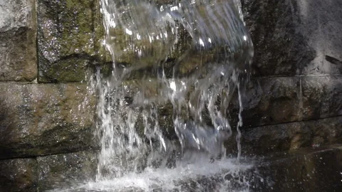 Water flows along a stone wall in slow motion Stock Footage 151113893