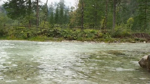 Water flows, in the background forest, mountains and fog Stock Footage 94668212