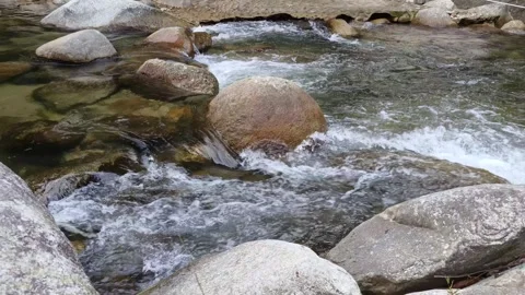 Water flows between rocks Stock Footage 297236581