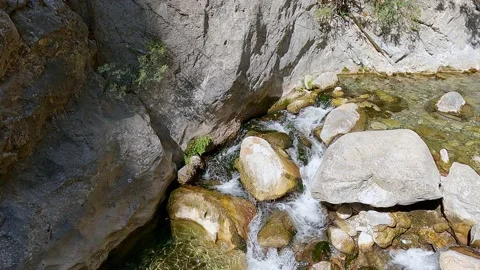 Water flows between rocks in mountain river in gorge Stock-Footage 163890206