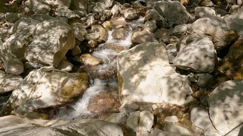 Water flows between rocks in mountain river in gorge 스톡 동영상 164584238