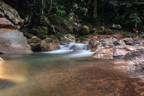 Water flows between rocks Stock Photos