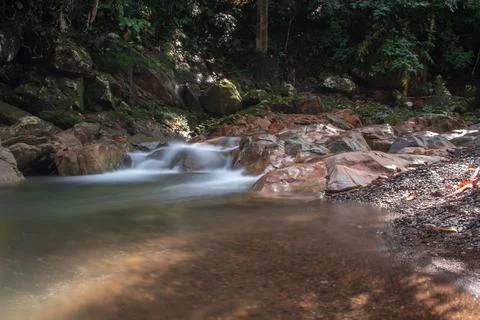 Water flows between rocks Stock Photos