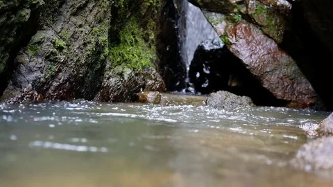 Water flows between the stones Stock Footage 82813577