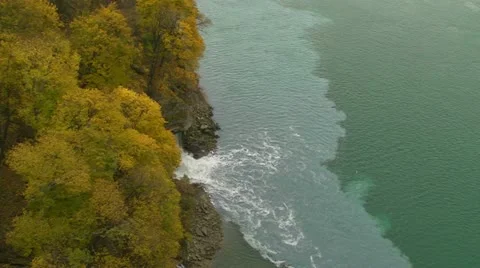 Water Flows between the Yellow Trees next to Niagara Falls Stock Footage