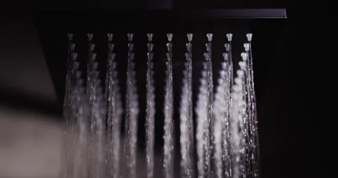 Water flows from a black square nozzle in the shower. 4k slow motion video Stock Footage 165809803