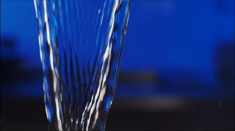 Water flows on a blue background Stock Photos