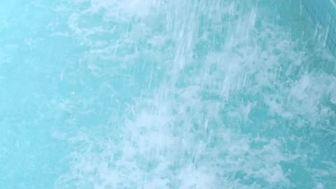 The water flows into the blue pool Stock Footage 264035423