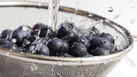 Water flows on blueberry Stock Footage 84975665