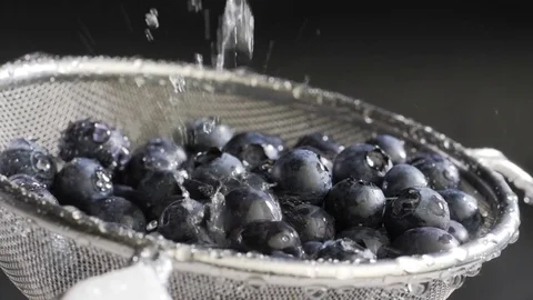 Water flows on blueberry Stock Footage 84976364