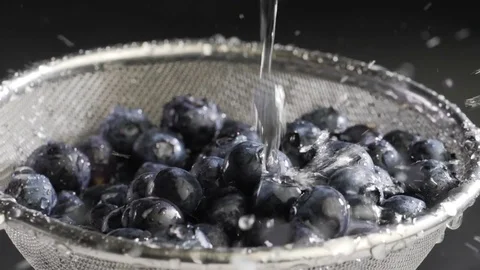 Water flows on blueberry Stock Footage 84976479