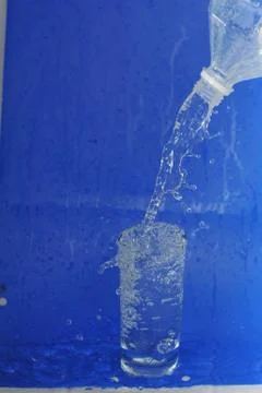 Water flows from  bottle Stock Photos