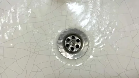Water flows to the bottom of the sink Stock Footage 228715471