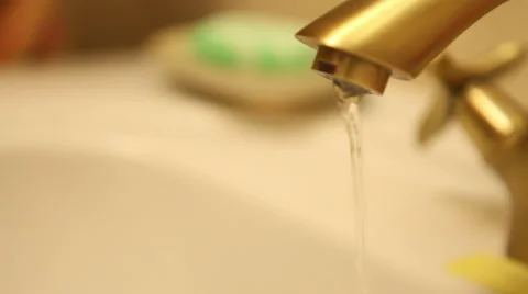 Water flows from a brass tap Stock Footage 60423614