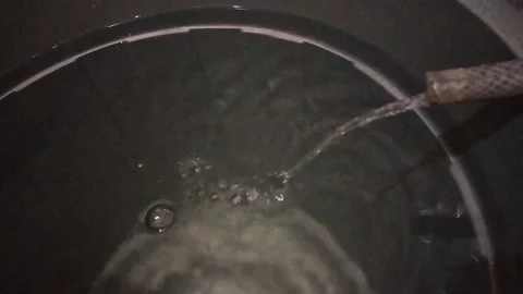 Water flows into the bucket Stock Footage 212636039