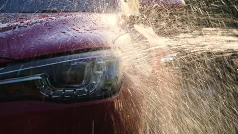 Water flows on the car while the worker is washing the car. 動画素材 188432824