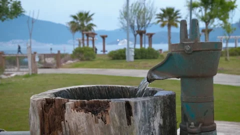 Water flows from a column on the street. Stock Footage 232959356