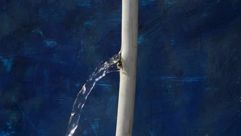 Water flows from a crack in the pipe. Stock Footage 143640625