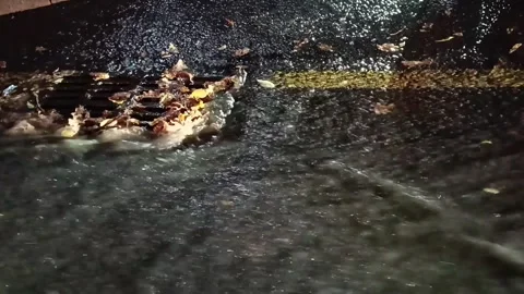 Water flows down the asphalt Stock Footage 255867309