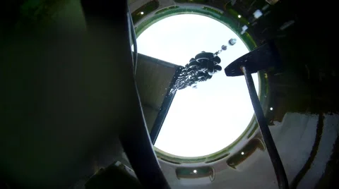 Water flows down into barrel through a chain Stock Footage 68171196