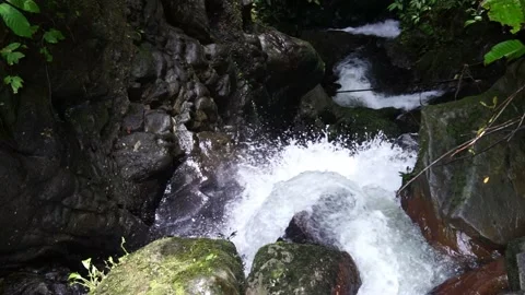 Water flows down cascading rocks. Top Down View  Waterfall Slo Mo  Stock Footage 238502189