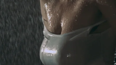 Water flows down the chest of a beautiful girl who takes a shower. Close-up Stock Footage 89500694