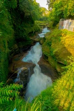 Water flows down Devi's Falls into the Gupteshwar Cave below in Pokhara, Nepal 스톡 사진