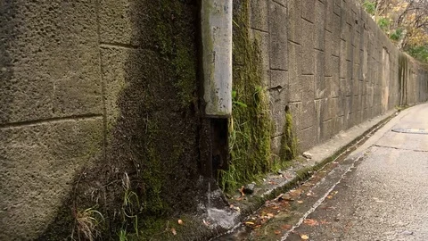 Water flows down the drain pipe. Stock Footage 121658504