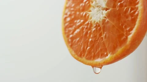 Water flows down from the edge of a beautiful juicy tangerine. Stock Footage 147138855