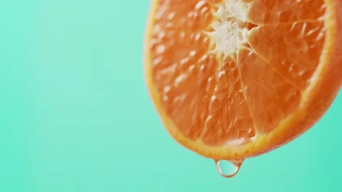 Water flows down from the edge of a beautiful juicy tangerine. Stock Footage 147140071