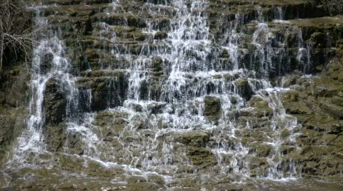 Water flows down the jagged rocks, creating waterfalls (High Definition) Stock Footage 365063