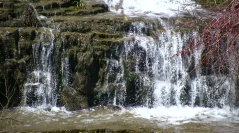 Water flows down the jagged rocks, creating waterfalls (High Definition) Stock Footage 365089