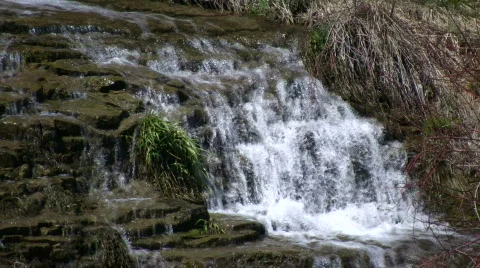 Water flows down the jagged rocks, creating waterfalls (High Definition) Stock Footage 365091