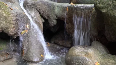 Water flows down a round rock formation Stock Footage 74291136