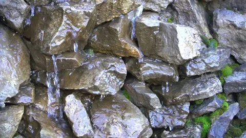 Water flows down stones Stock Footage
