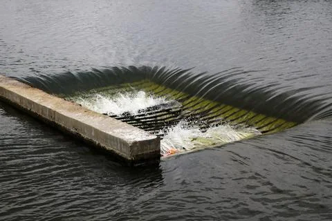 Water flows down through the grate. Water drainage. 스톡 사진