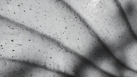 Water flows down a vertical embossed stone wall in close-up.  Stock Footage 337938239