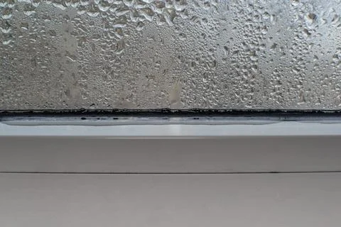 Water flows down from the window glass Stock Photos