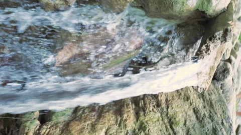 Water flows down a wooden trough, vertical video Stock Footage 167997076