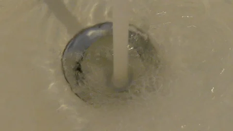 Water flows into the drain of a sink, sink Stock Footage 125898529