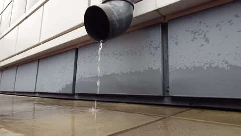 Water flows from a drainage pipe Stock Footage 335544640