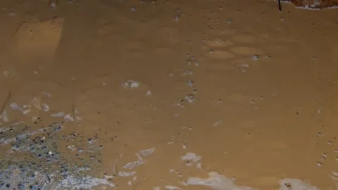 Water flows from a drilling site during well construction in the daytime Stock Footage 336792758