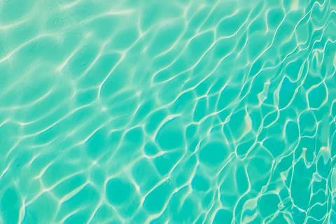 Water flows gently in  clear pool reflecting sunlight during day. Clear water Stock Photos