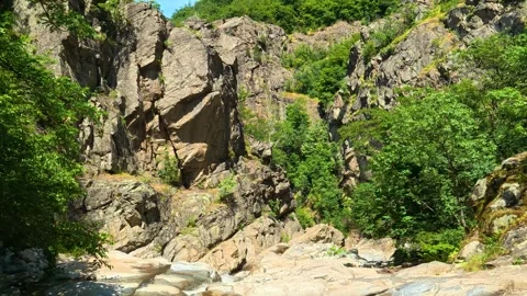 Water flows gently over smooth stones. Vucjanka Canyon, Serbia Видео 341127700