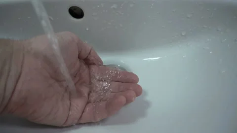 Water flows on a hand in the sink in slow motion Stock Footage 135264347