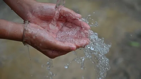 The water flows on the hands of people video Slow motion 120 frames Stock Footage 106399808