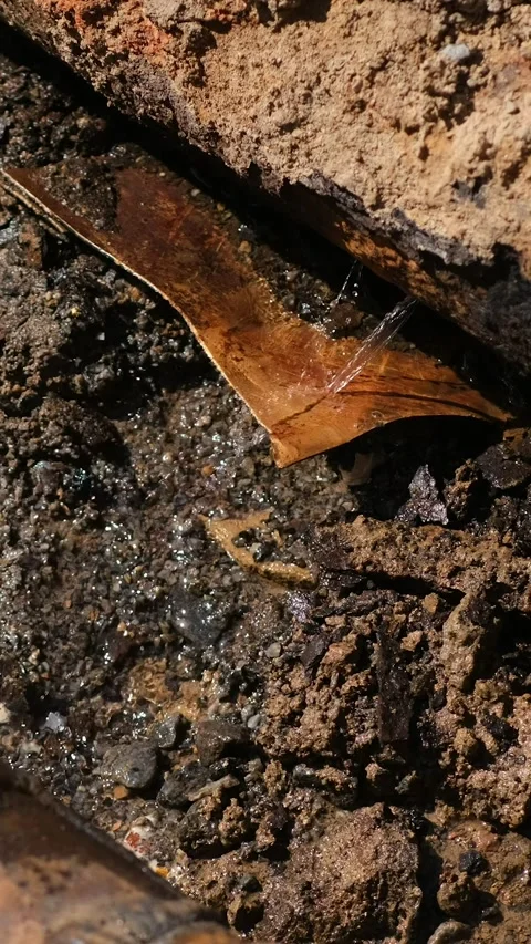 Water flows from the hole rusty pipes. Repair of old water pipes. Stock Footage 285706307